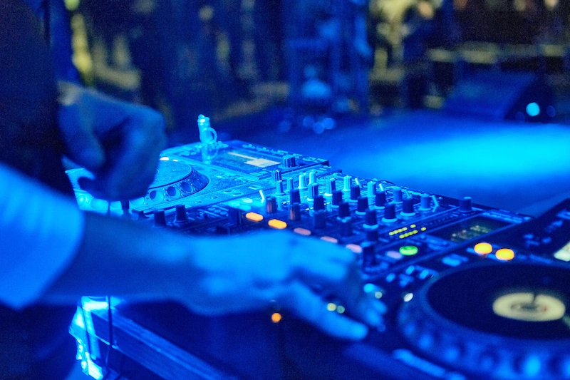 Close-up of a DJ mixer lit in blue at a Maryland event