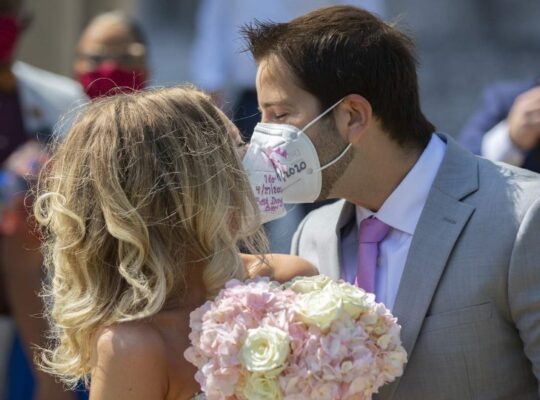 Bride and Groom Kissing with Masks